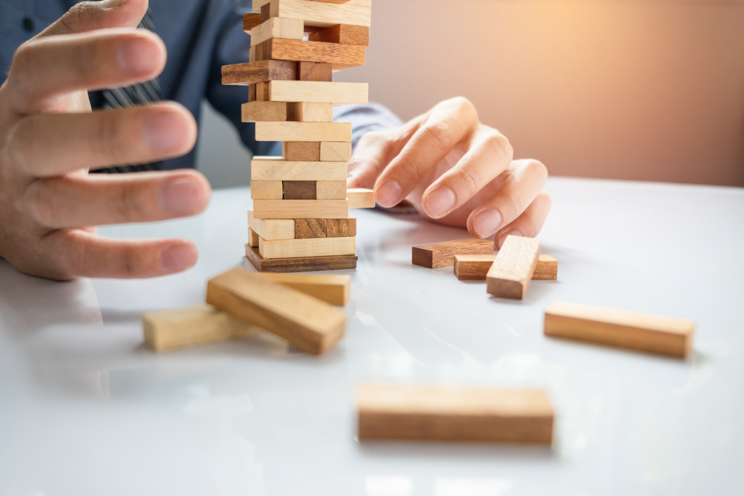 planning risk strategy business businessman gambling placing wooden block tower